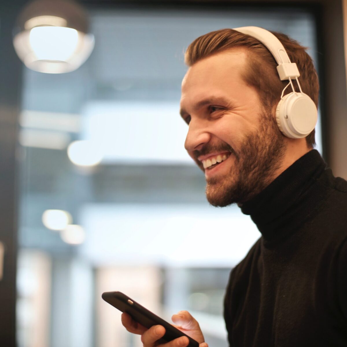 Man laughing with headphones on